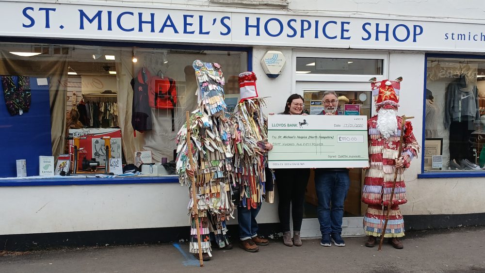 Overton Mummers presenting a cheque to us outside our shop in Overton.